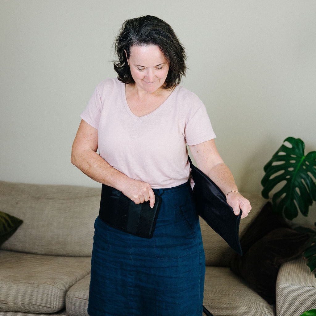 Woman adjusting the back cuff to suit