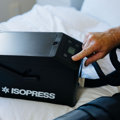 Person using an ISOPRESS device on a bed