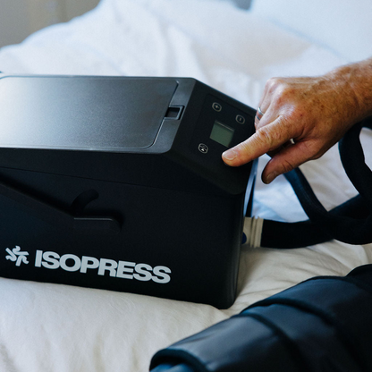 Person using an ISOPRESS device on a bed